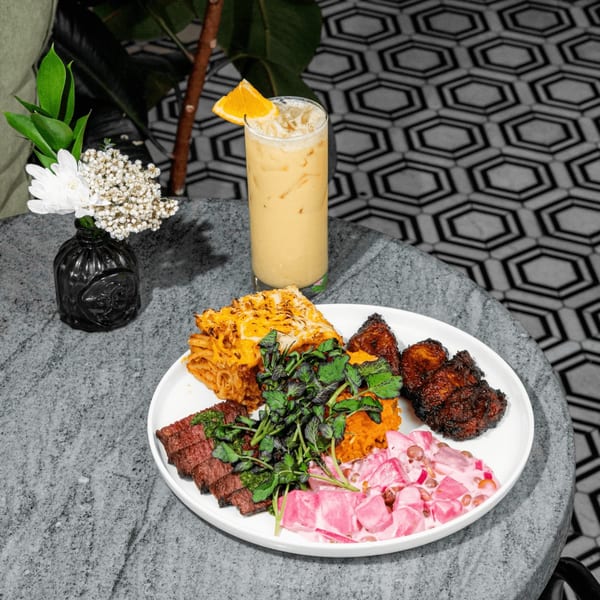 A HAAM Caribbean Plant Cuisine vegan platter with plantain mac and cheese, plant-based ribs, and salads.
